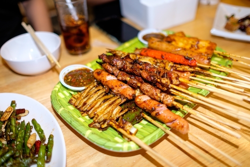 espetinhos de carne da culinária asiática em uma mesa - atividades noturnas - Assaí Atacadista - Imagem: shutterstock
