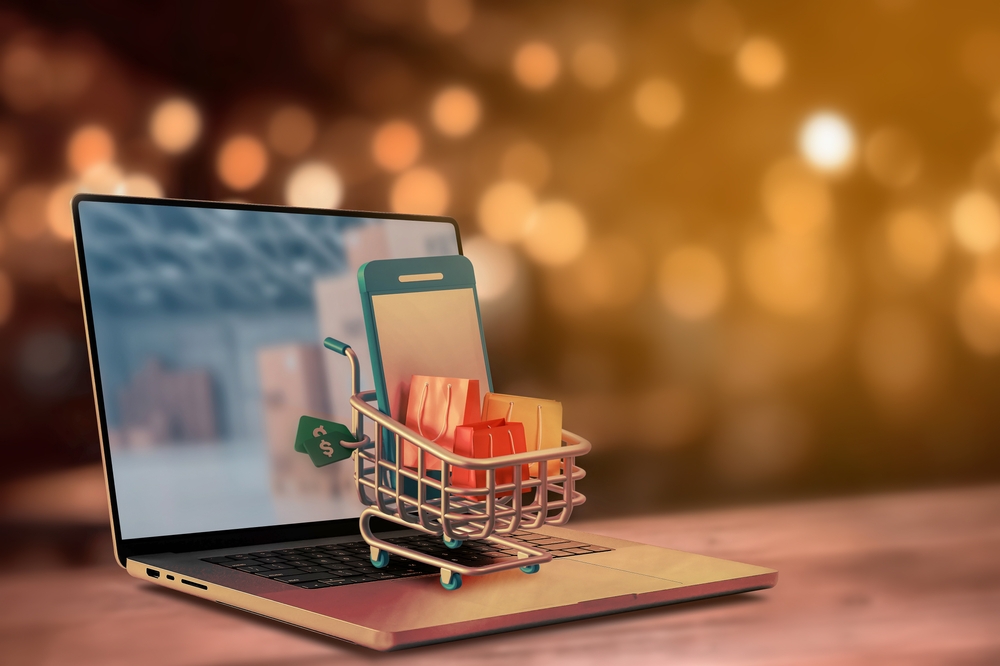 notebook com minicarrinho de compras com sacolas e um celular dentro - economia de tempo - Assaí Atacadista
