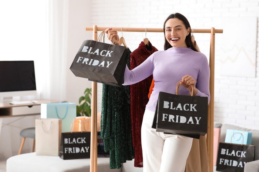 mulher branca feliz segurando sacolas pretas-Assaí Atacadista-Compras seguras