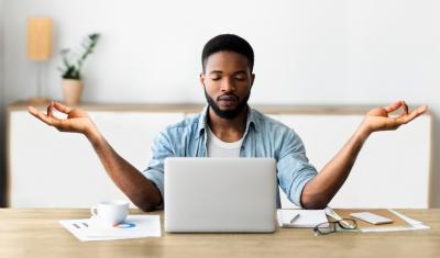 jovem rapaz negro concentrado meditando em frente a um notebook - habitos para praticar - Assaí Atacadista