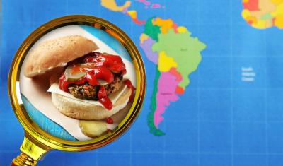 lupa com hamburguer com um mapa mundial no fundo - hamburgueres exóticos - Assaí Atacadista